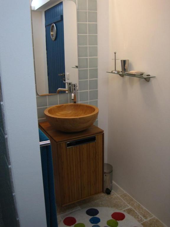 a bathroom with a wooden sink and a mirror at Le Mas Nomade in Callian