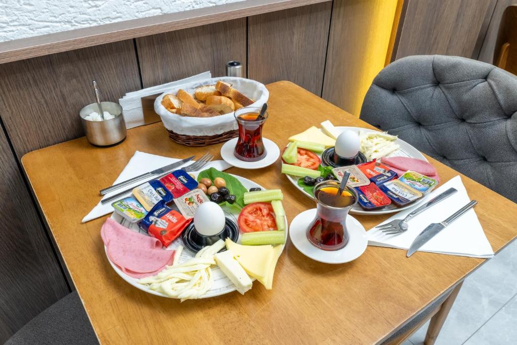 a table with plates of food and a bowl of food at Luxury Life Suites in Istanbul