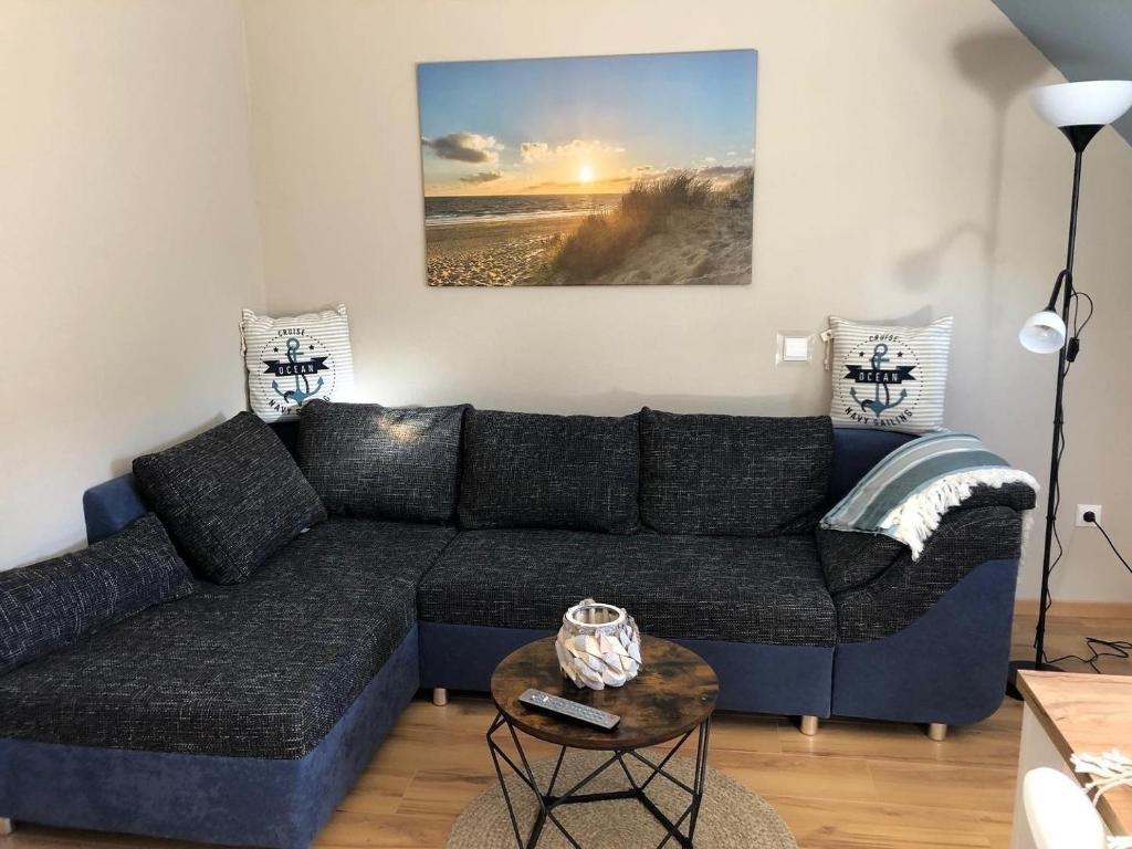 a living room with a couch and a table at Ferienwohnung Kalle in Osterbruch