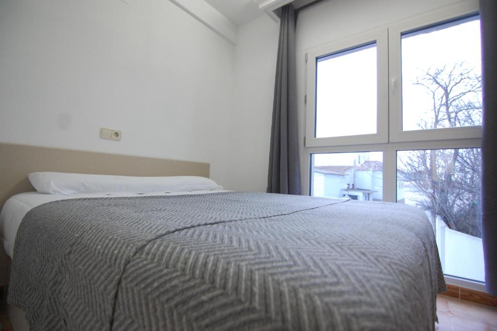 Postel nebo postele na pokoji v ubytování El Hostal 36