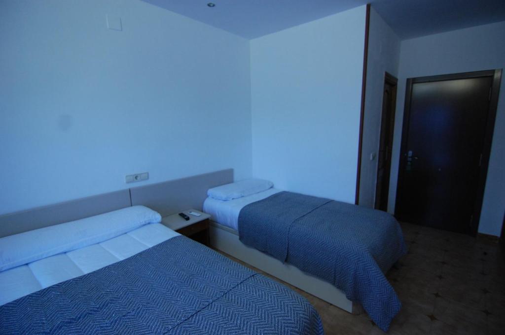 Postel nebo postele na pokoji v ubytování El Hostal 36