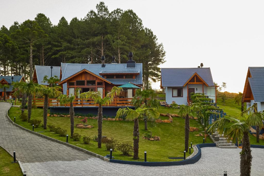 a house on a hill with palm trees at Hospedaria Morada das Grimpas in Palmeira