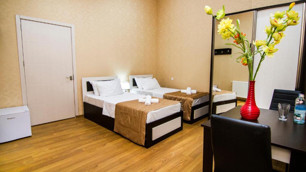 Postel nebo postele na pokoji v ubytování Hotel Care Inn