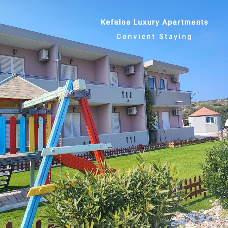 a playground in front of a building at Kefalos Luxury Apartments in Kefalos