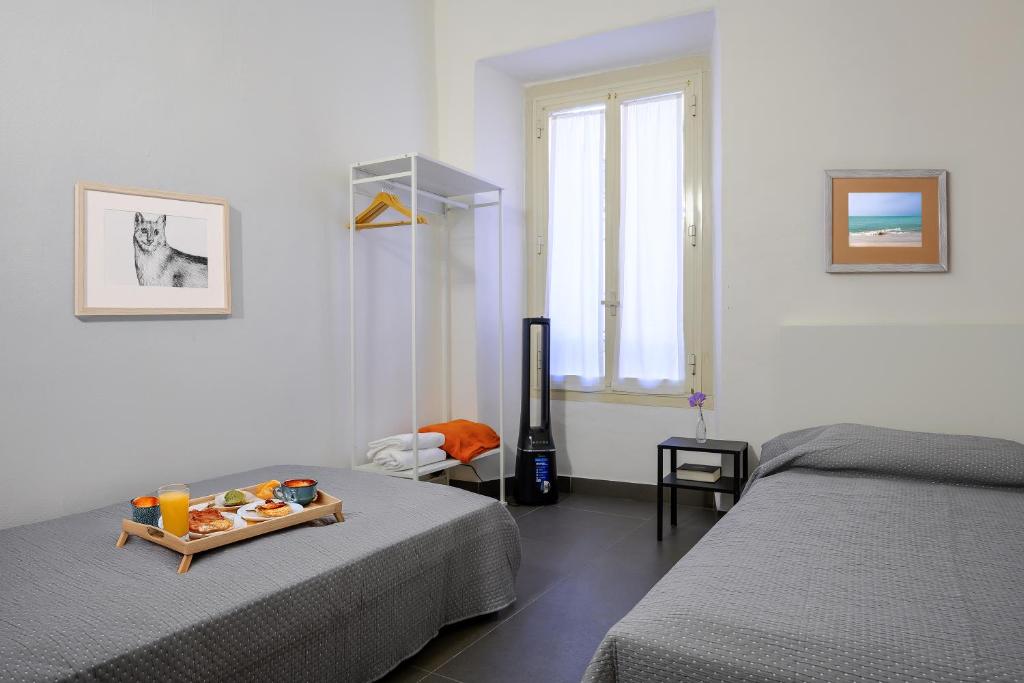 En eller flere senge i et værelse på Dimora Novecento