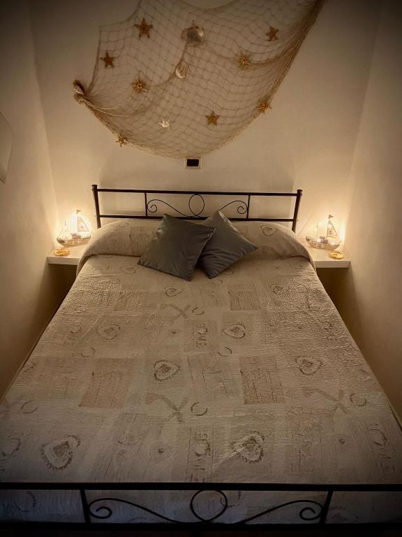 a bedroom with a large bed with two night stands at Casa Gioia in Chioggia