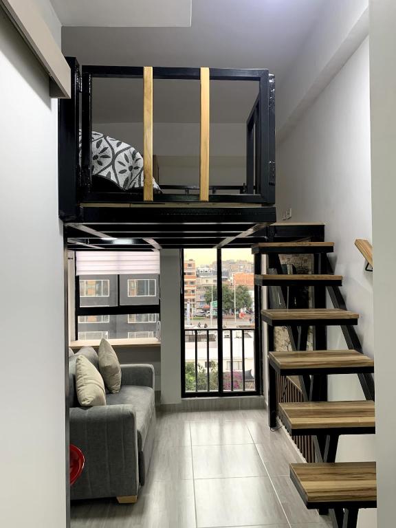 a living room with a loft bed and a couch at Apartment in La Castellana in Bogotá