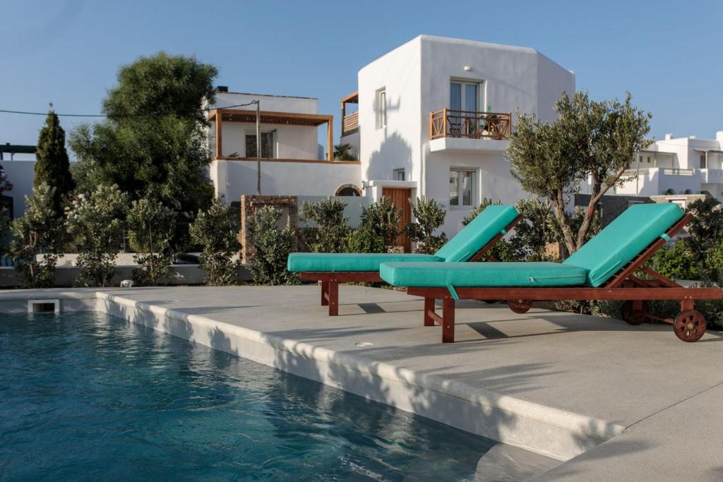 a pool with two lounge chairs next to a building at Summer Sense, New Private Retreat with Private Pool, Agia Anna, Naxos in Agia Anna