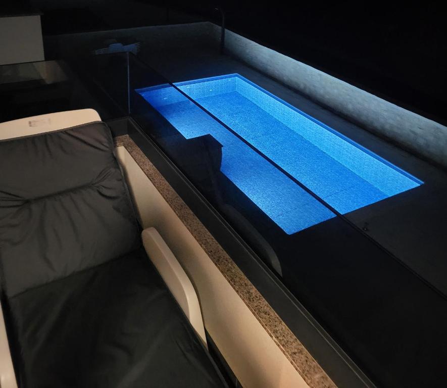 a bed with a swimming pool in a room at Apartment Mare D with a pool new in Novalja