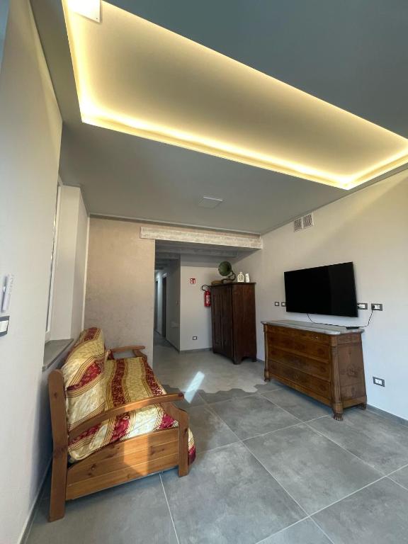 a room with two beds and a flat screen tv at airport apartments camera relax in San Maurizio Canavese