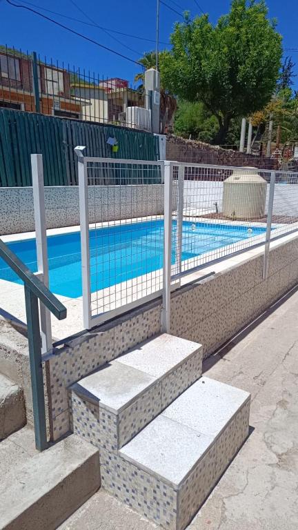 a fence next to a swimming pool with stairs at LUSANYUN 1 in Villa Independencia