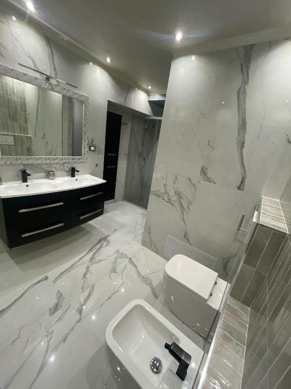a white bathroom with a sink and a toilet at airport apartments camera narciso in San Maurizio Canavese