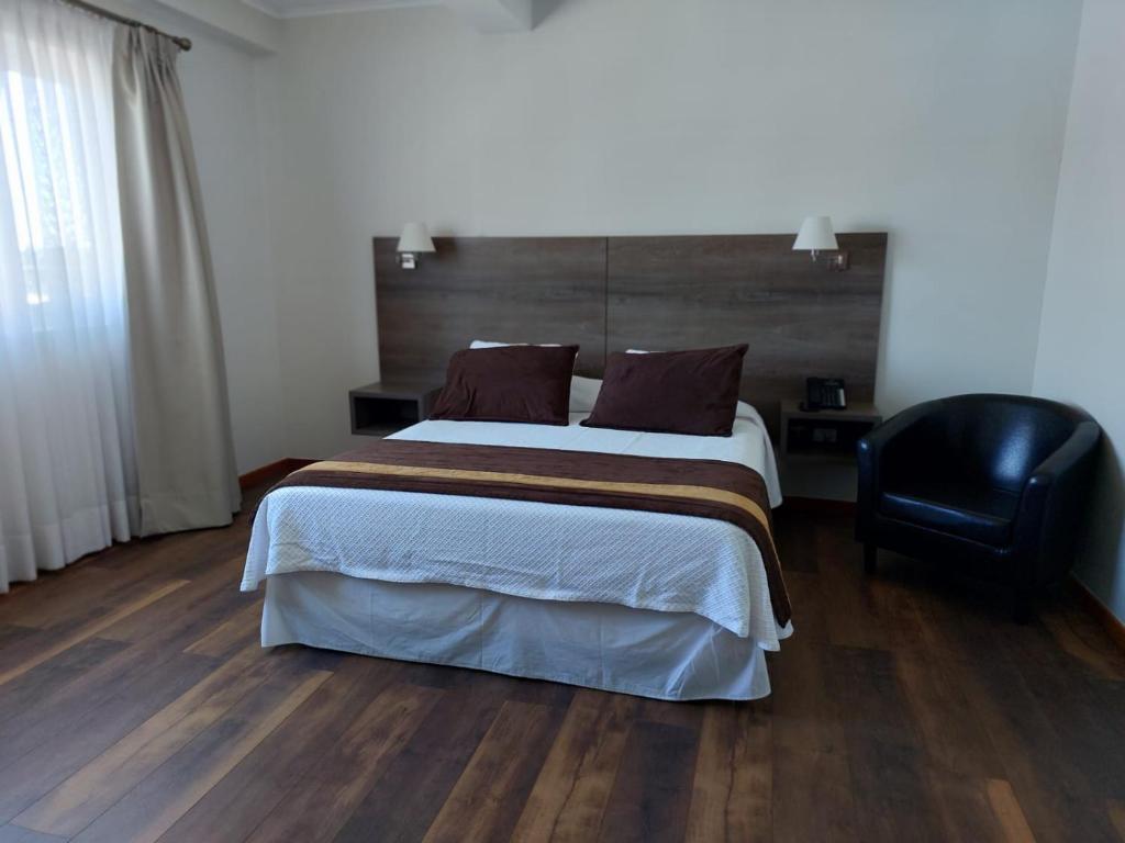 Postel nebo postele na pokoji v ubytování Conrado Hotel Osorno
