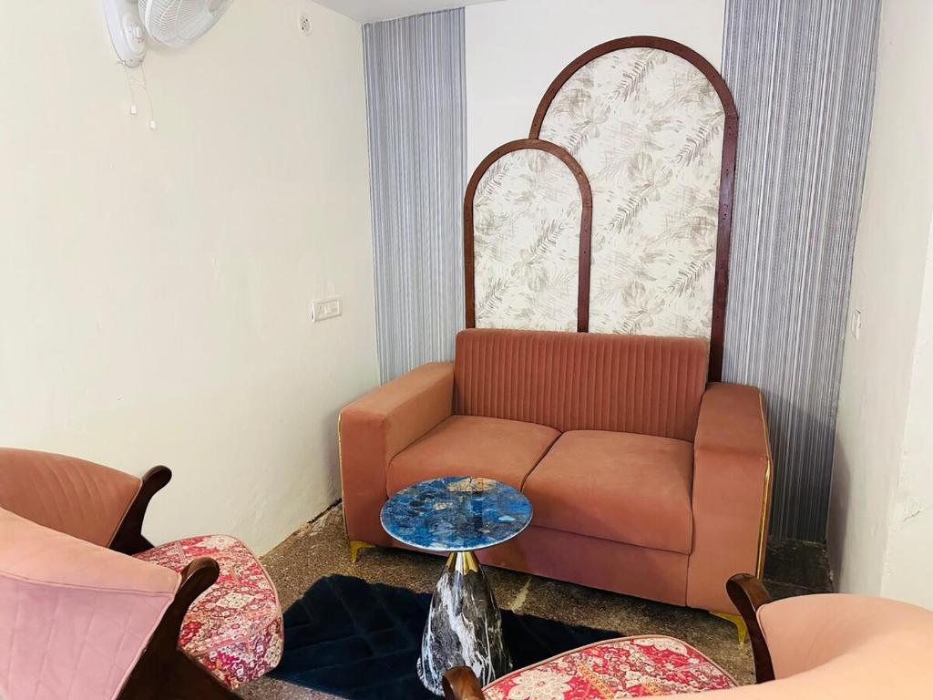 a living room with a couch and a table at Kamaree-7BHK in Varanasi