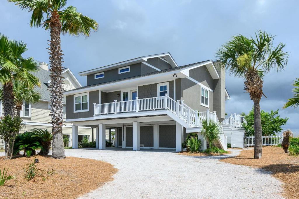 a large house with palm trees in front of it at One Particular Harbor - Harbor Island Oceanfront, Private Pool! in Cedar Reef Villas