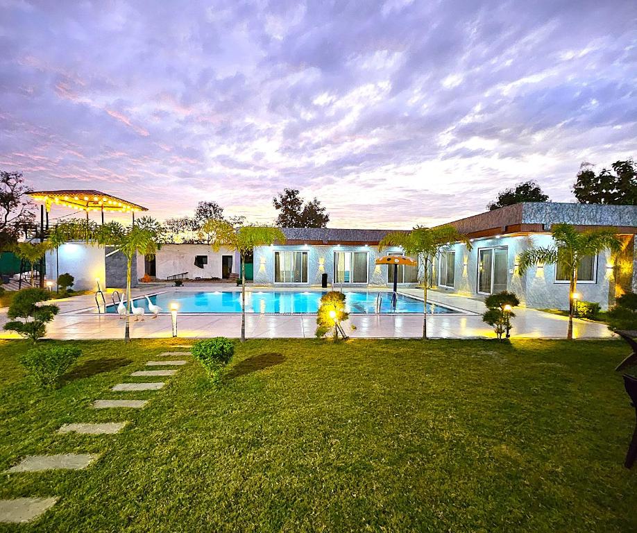 a house with a swimming pool in a yard at Voco Farms & Resorts in Simrol