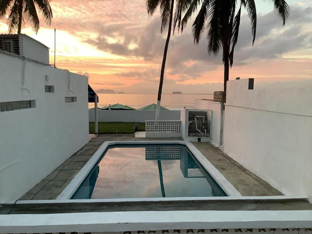a swimming pool on the roof of a house at Casa GALLARDO in Manzanillo