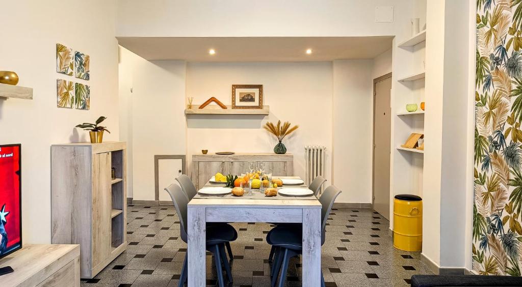 a dining room with a white table and chairs at MITO Sea Apartment in Porto San Giorgio