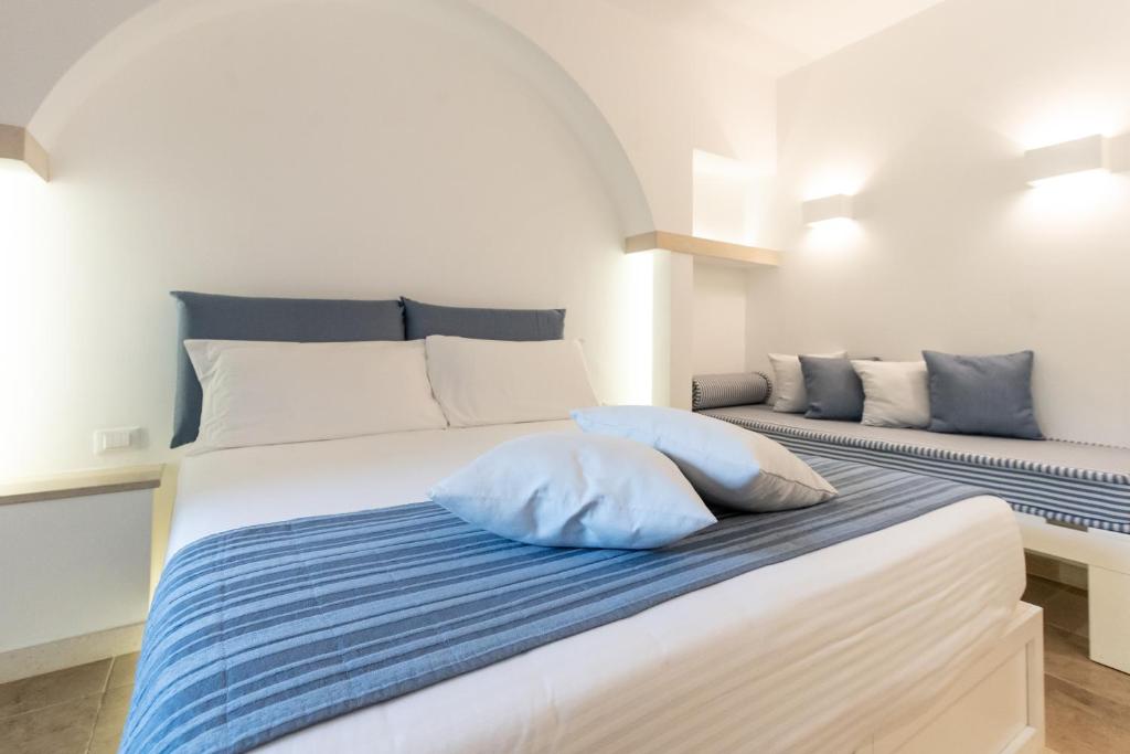 a white bed with two pillows on top of it at Ostuni a Mare in Ostuni