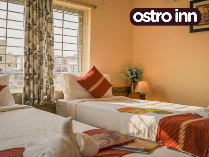 Postel nebo postele na pokoji v ubytování Ostro Inn New Town