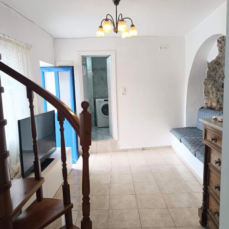 a living room with a staircase and a bathroom at Perno in Serifos Chora