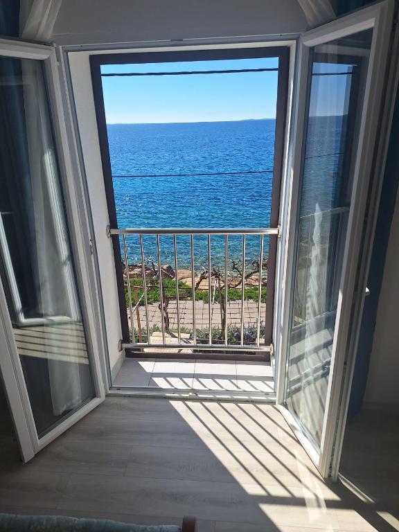 a balcony with a view of the ocean at Bravarica blue in Potocnica