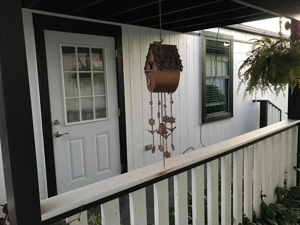 a porch of a house with a door and a planter at Cozy Cabin in Brazoria
