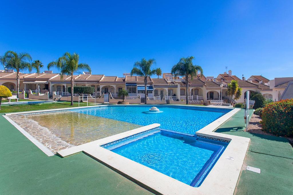 a large swimming pool in front of a house at CH Limonero Doña Pepa in Rojales