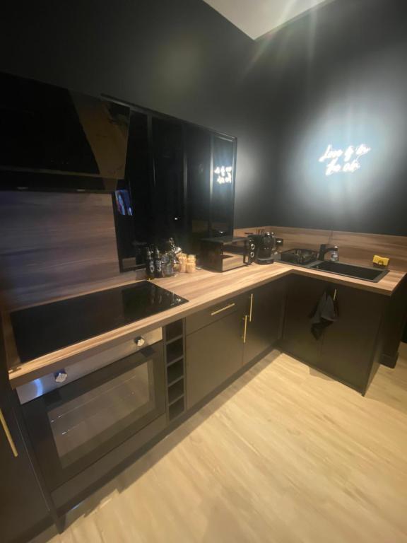 a kitchen with a counter with a sink and a stove at Romantic apartment near Paris in Maintenon