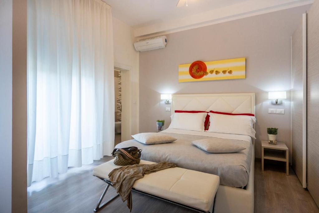 a bedroom with a king sized bed and a window at Hotel Sammaritani in Rimini
