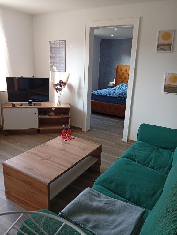 a living room with a couch and a bed at Ferienwohnung Ostfriesland in Stapelmoor
