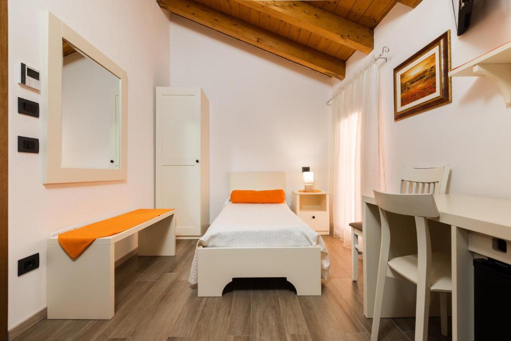 Postel nebo postele na pokoji v ubytování Hotel AL COLLIO