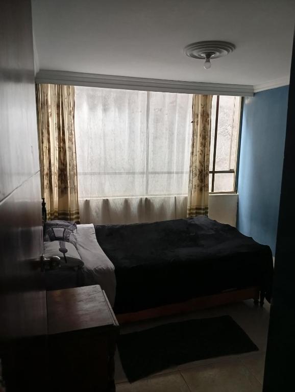 Postel nebo postele na pokoji v ubytování Bogotá Med plus