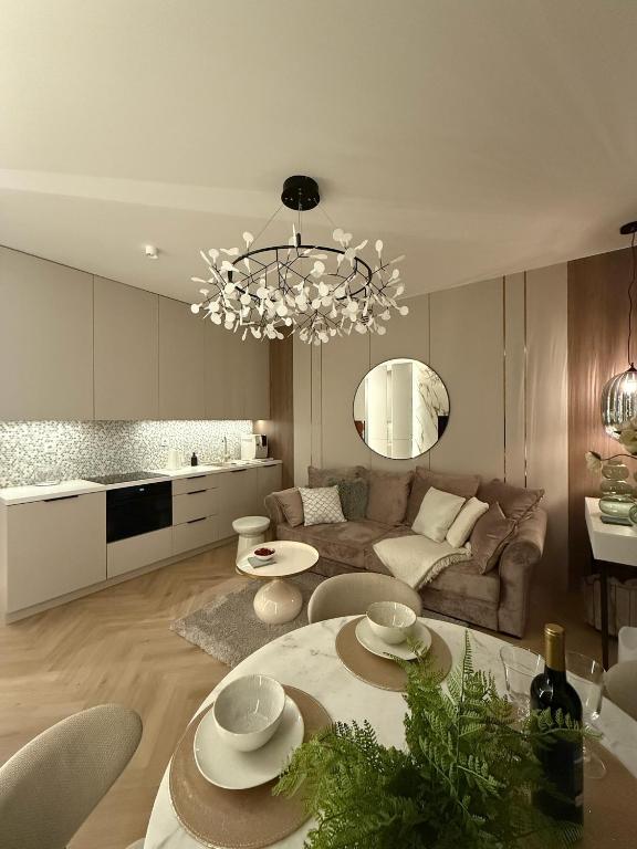 a living room with a couch and a table at Apartament Pod Żaglami 2 in Sława