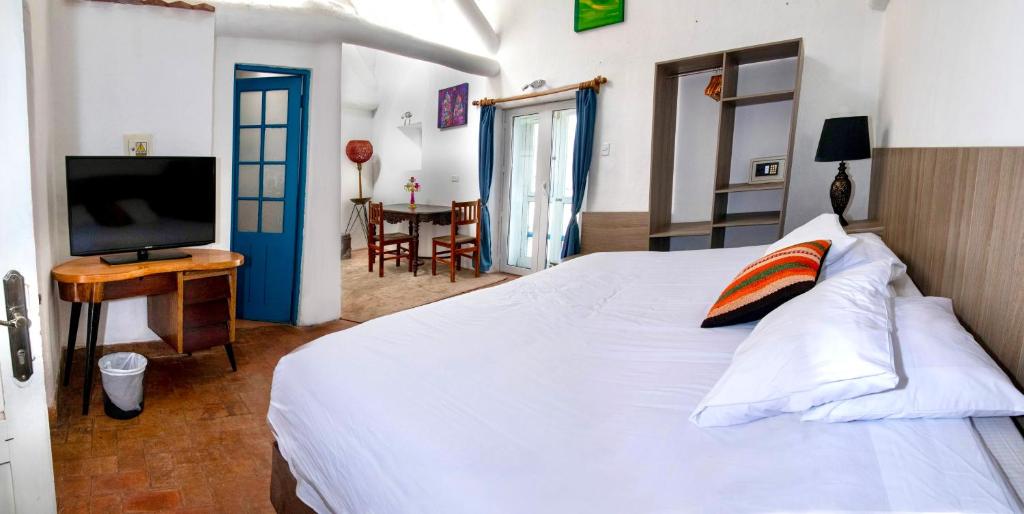 Postel nebo postele na pokoji v ubytování Inkarri Cusco