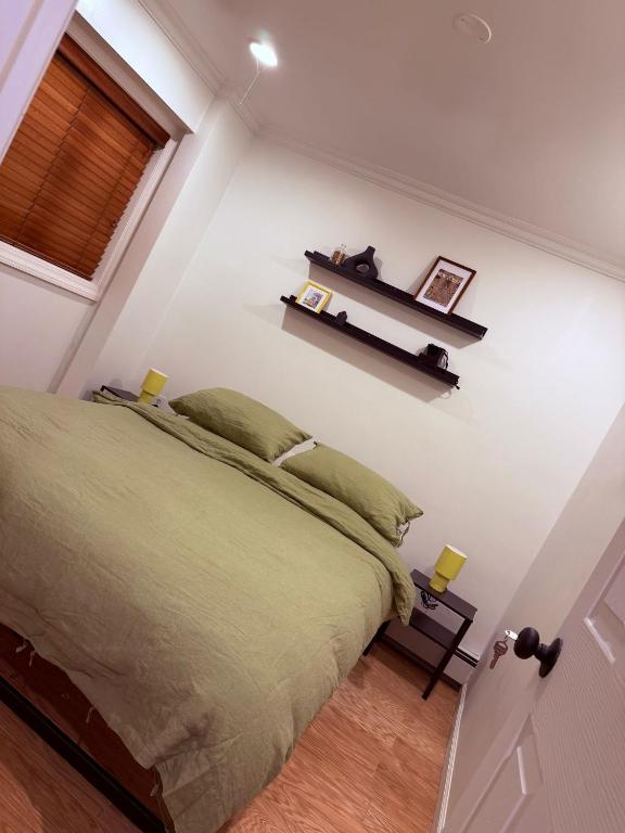 a bedroom with a bed and a shelf on the wall at The Plateau Chateau in Queens