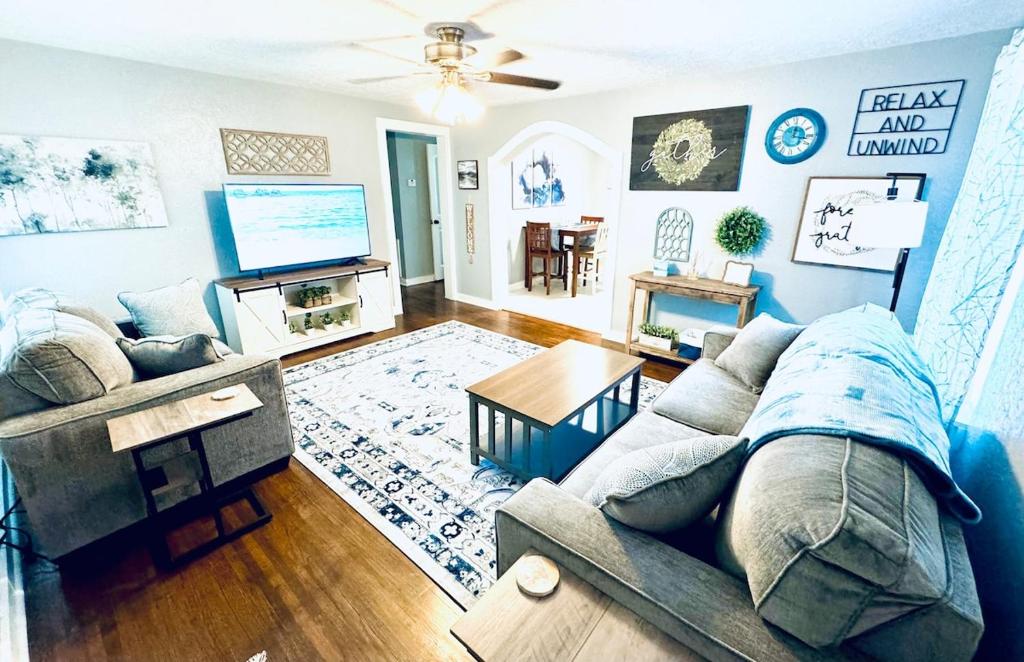 a living room with a couch and a tv at Relax & Unwind in 2BR 1BA Home in Quiet Neighborhood in Nederland