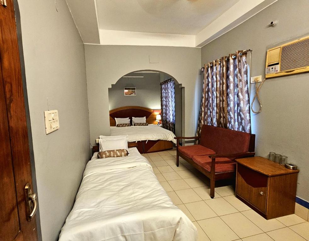 Postel nebo postele na pokoji v ubytování Hotel Vishal