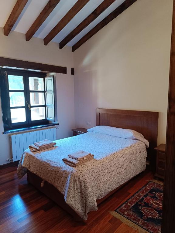 Un dormitorio con una cama con dos toallas encima. en The living mountain - SAJA - CASONA RURAL, en Saja