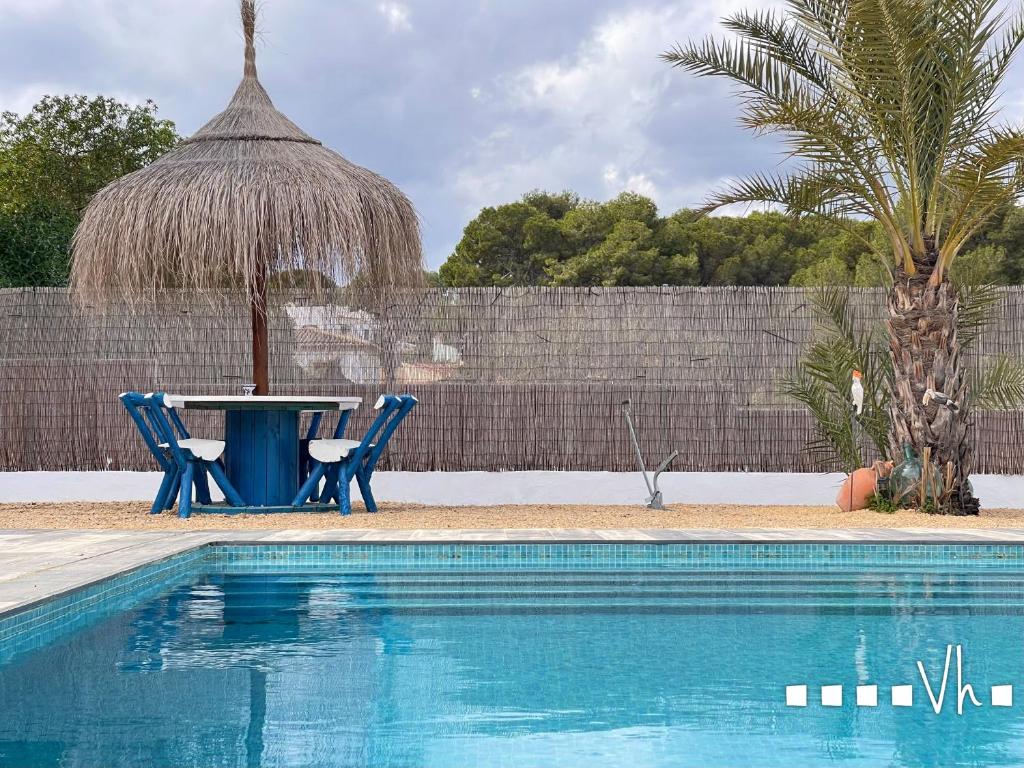 a table and chairs next to a swimming pool at VH CostaBlanca - LA COMETA in Teulada