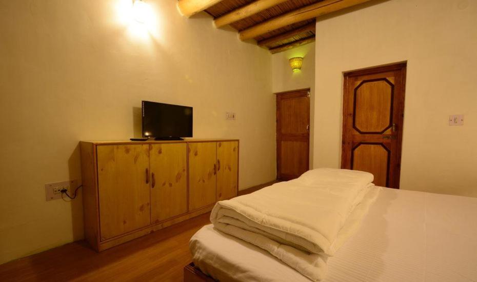 Postel nebo postele na pokoji v ubytování yangphel house