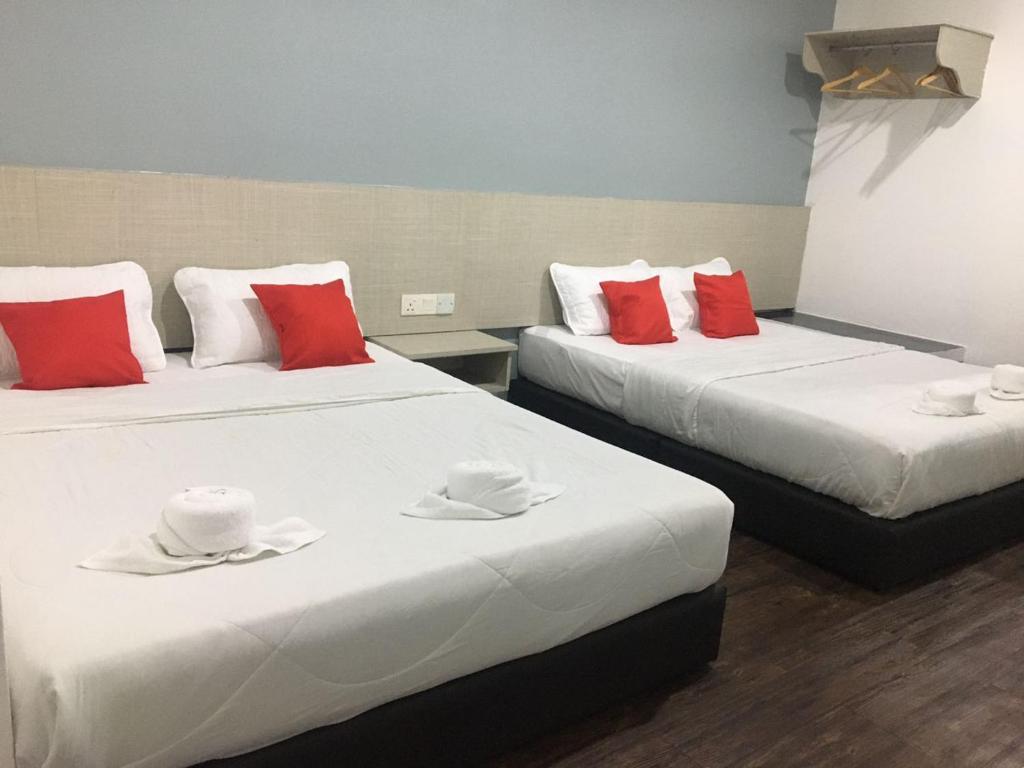 Postel nebo postele na pokoji v ubytování Rg Hotel Ayer Hitam