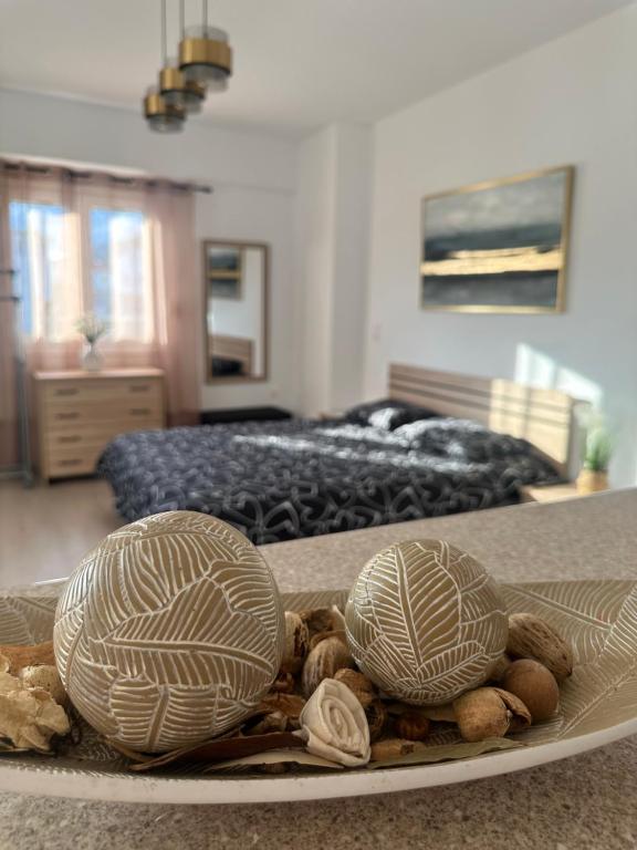 two shells on a plate on a table in a bedroom at Parthenis appartments in Pythagoreio