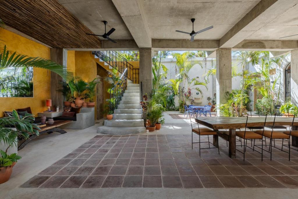 a patio with a table and chairs and plants at El Mambo Boutique Hotel in Las Terrenas