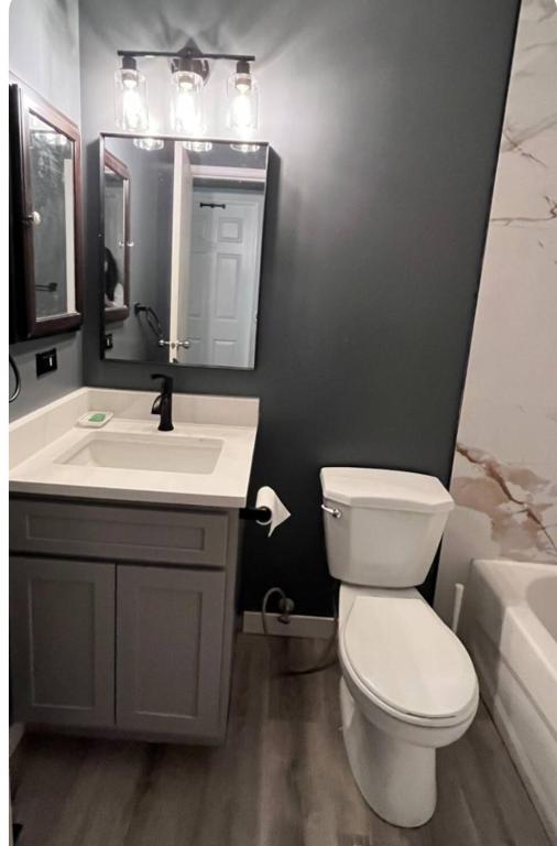 a bathroom with a white toilet and a sink at Gorgeous House&30 second Bus station Close C-Train& Free Parking in Calgary