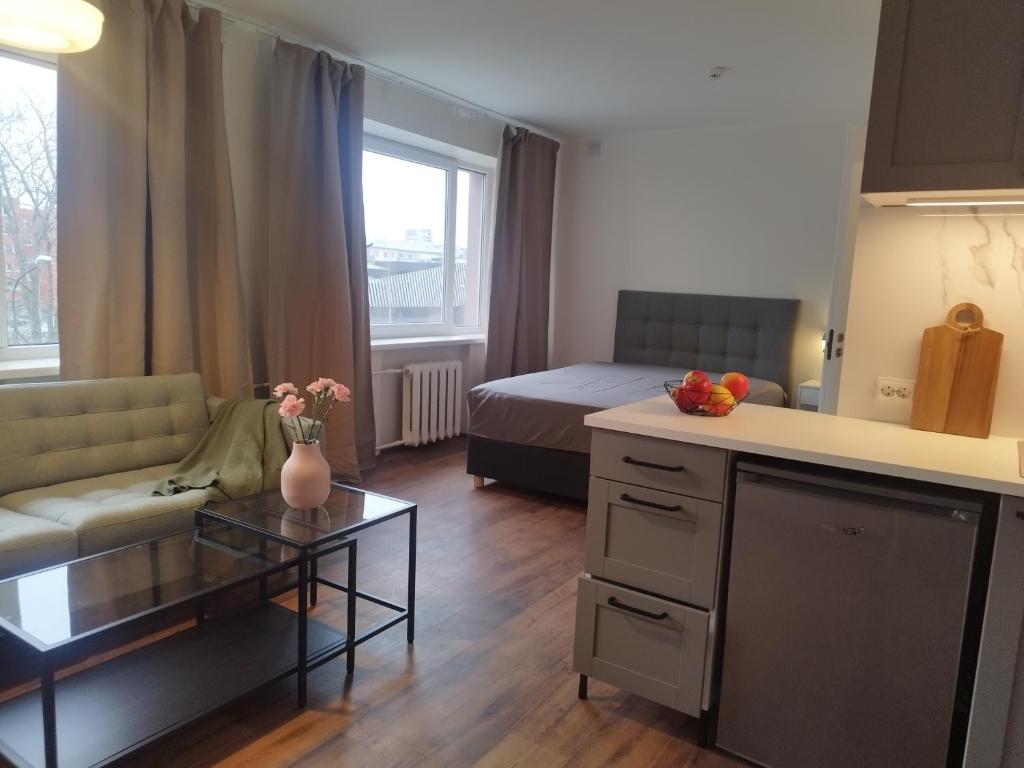 a living room with a couch and a table at MYROOM-2 near the center and the Stroomi beach in Tallinn