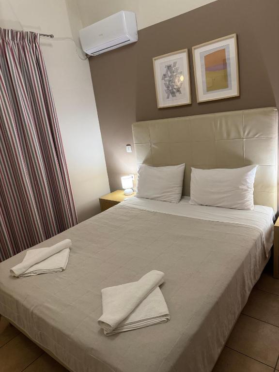 Łóżko lub łóżka w pokoju w obiekcie Antonia Apartments