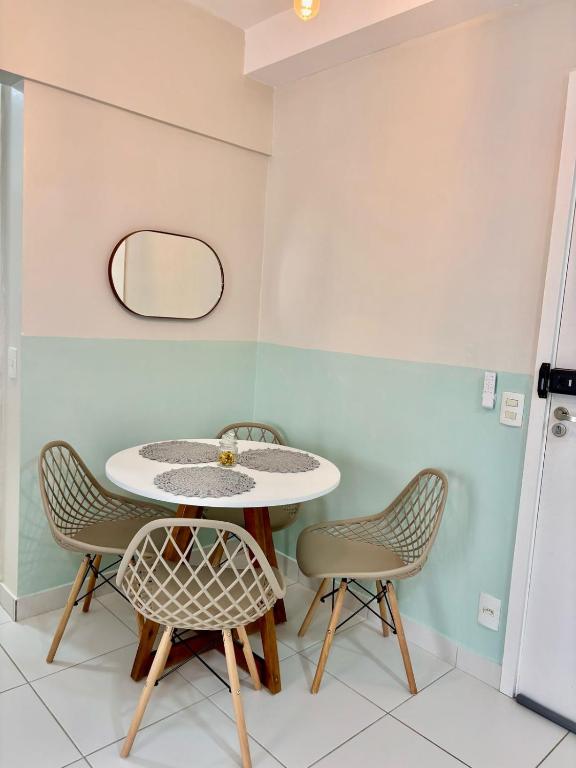 a table and chairs in a room with a mirror at Desativado in São Luís