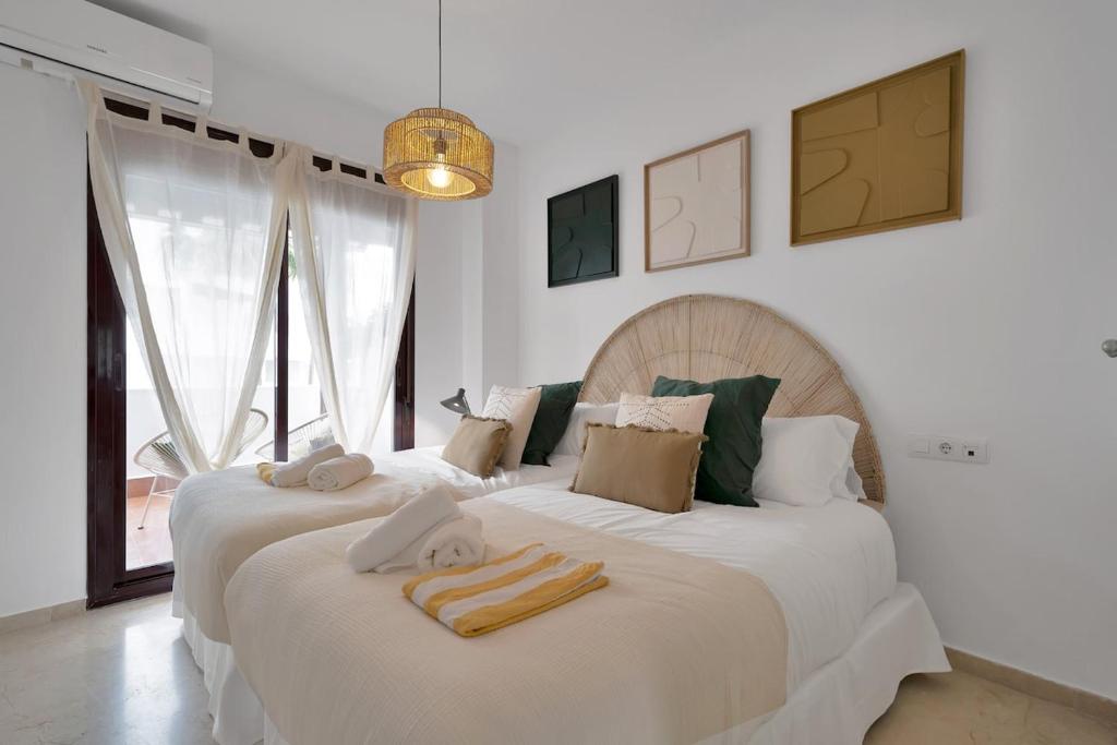 a bedroom with two beds with towels on them at Elegance and luxury with a pool in Miraflores Golf - CASA GOLF RIVIERA PARK 3 2 E in Mijas Costa