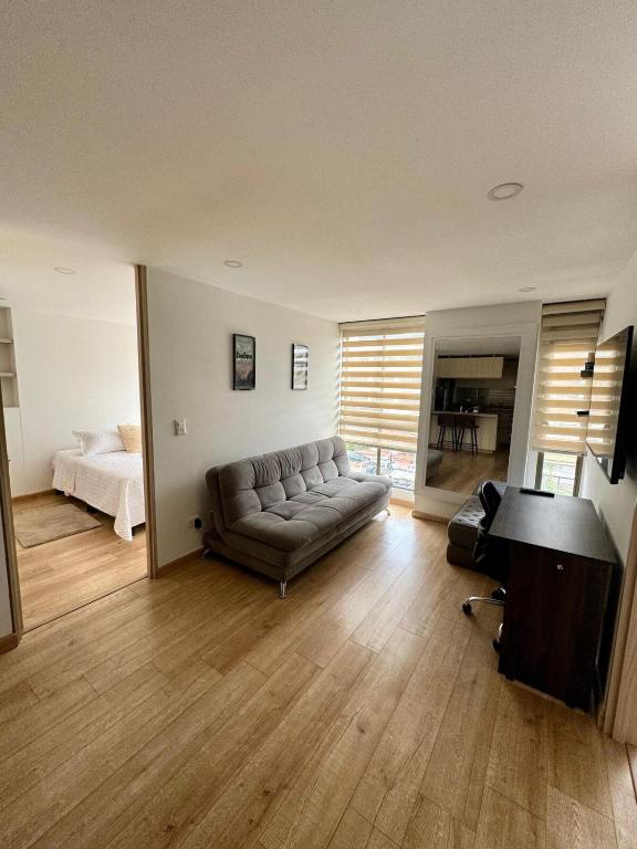 a living room with a couch and a bed at Wonderful place in Usaquen! in Bogotá